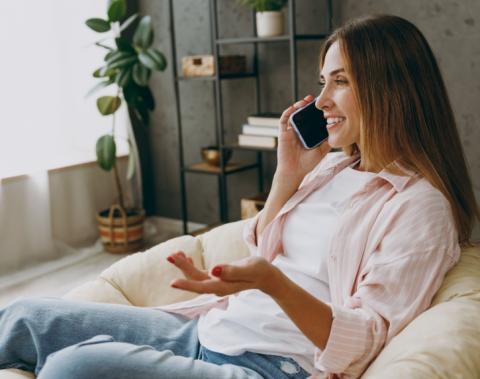 A woman talking on the phone at home. 